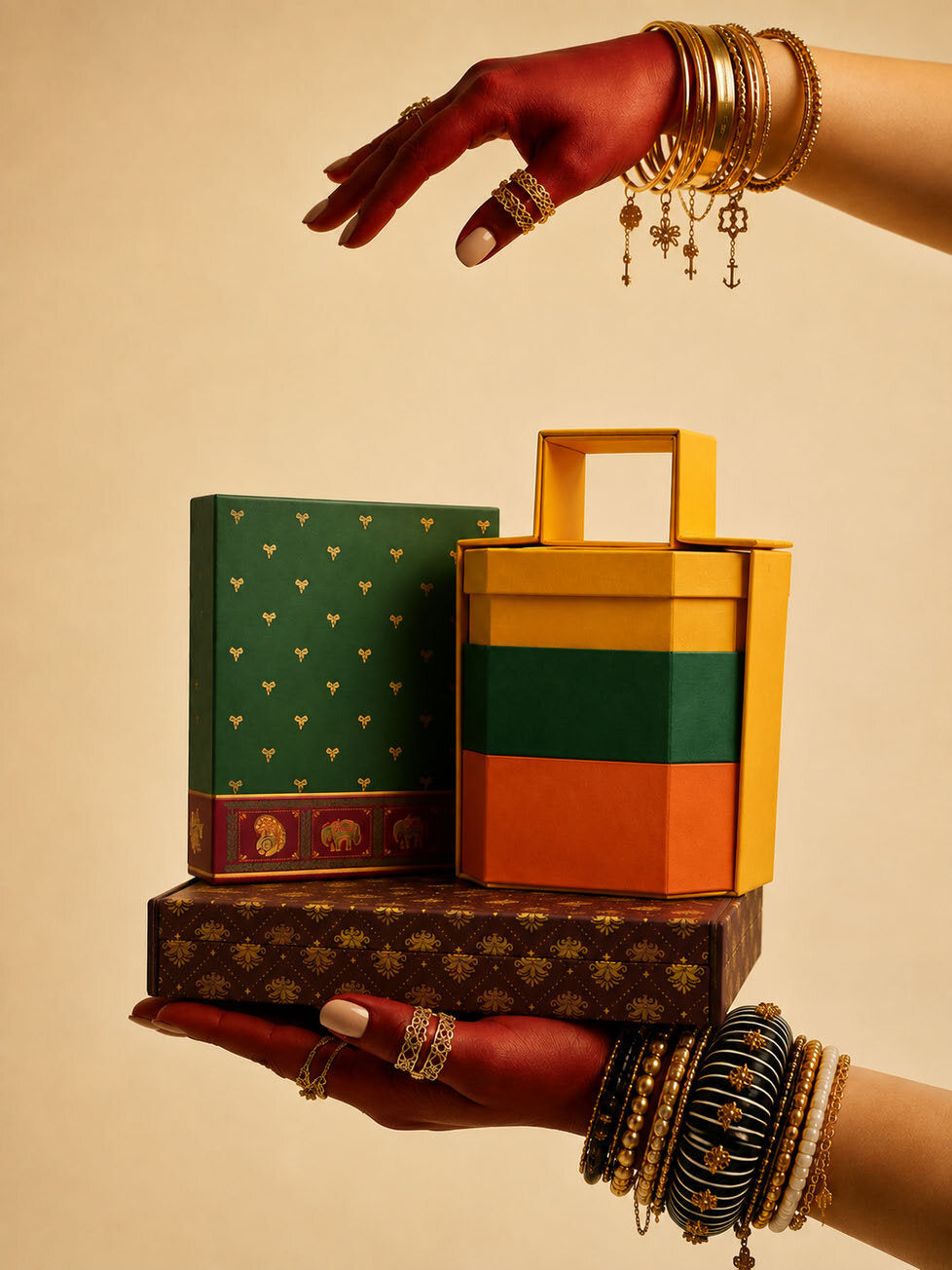 Hands holding stacked Diwali gift boxes